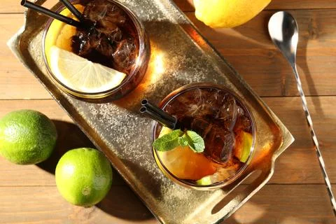 Refreshing Cuba libre cocktail with mint on wooden table, flat lay 스톡 사진