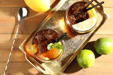 Refreshing Cuba libre cocktail with mint on wooden table, flat lay 스톡 사진