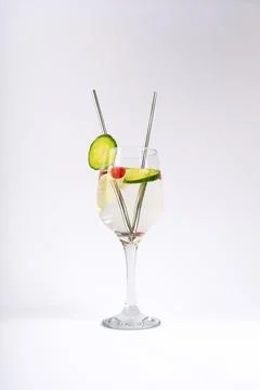 Refreshing Cucumber and Raspberry Infused Water in Elegant Wine Glass with .. Stock Photos