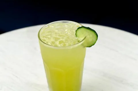 Refreshing cucumber lemonade drink served in a tall glass with ice Stock Photos