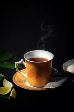 A Refreshing cup of Ceylon Tea. Isolated in black background. Stock Photos