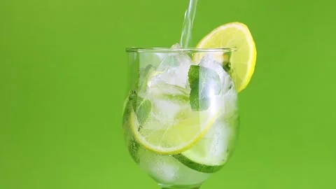 Refreshing detox summer drink lemonade with ice is poured into a glass. Tonic  Stock Footage 168415172