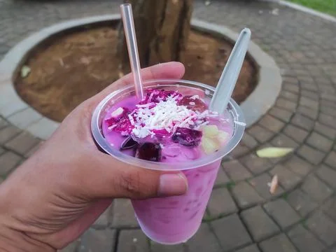 Refreshing dragon fruit ice drink with grated cheese sprinkled on it. Stock Photos