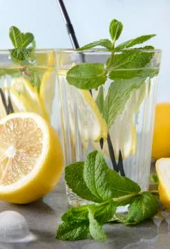 Refreshing drink, close up , 2 glasses of lemonade with yellow lemon and mint Stock Photos