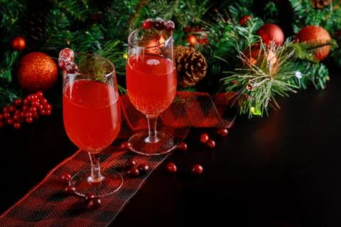 Refreshing drink with cranberries black background with decor. Stock Photos