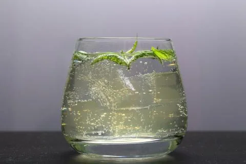 Refreshing drink with gas bubbles. Nalit in a transparent glass. It laid crus Stock Photos