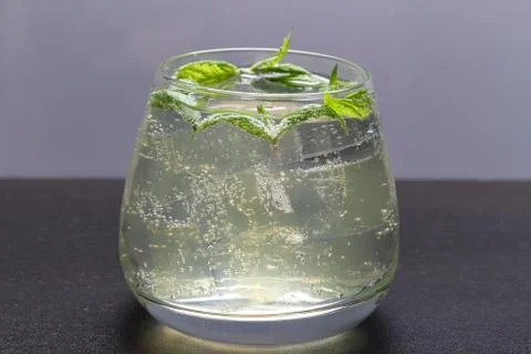 Refreshing drink with gas bubbles. Nalit in a transparent glass. It laid crus Stock Photos