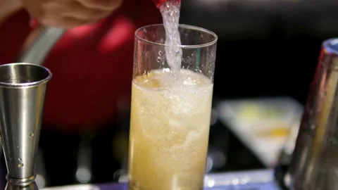 Refreshing drink in glass with ice, black background Video stock 326629508