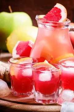 Refreshing drink with grapefruit, apples and ginger, old wooden background, s Stock Photos