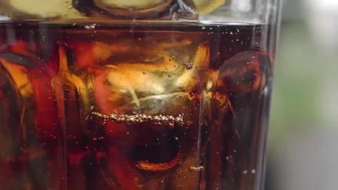 Refreshing drink with ice and bubbles in glass Stock Footage 336984363