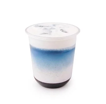 Refreshing drink with layers of blue and white served in a clear cup 写真素材