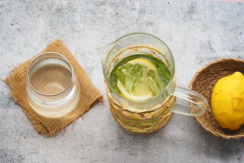 Refreshing drink with lemon and mint on a textured surface Stock Photos