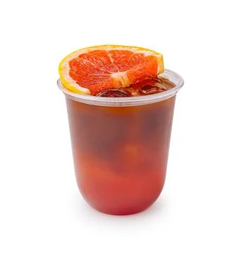 Refreshing drink with orange slice in clear cup on white background Stock Photos