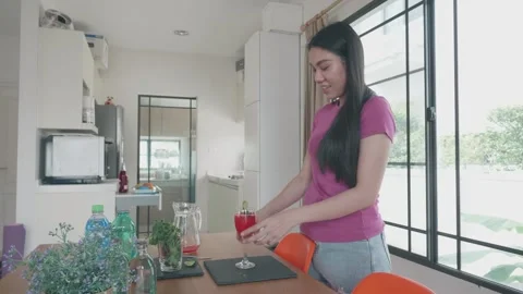 Refreshing Drink Preparation in a Modern Kitchen Stock Footage 314510778