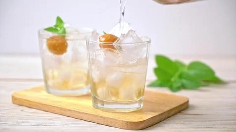 Refreshing drinks with ice, fruit, and mint on wooden board Stock Photos