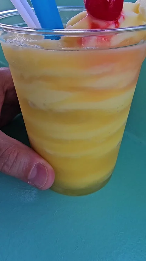 Refreshing frozen drink getting stirred with large drinking straw vertical video Stock Footage 335430215
