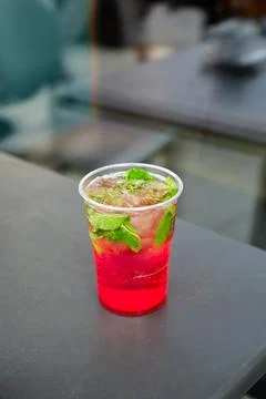 Refreshing fruit lemonade in a plastic cup Stock Photos
