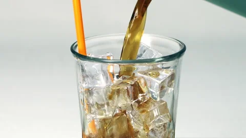 Refreshing Glass of Carbonated Drink with Ice Cubes and Bubbles Featuring O.. Stock Footage 314331561