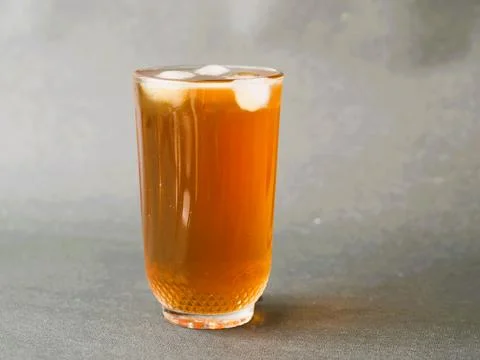 A refreshing glass of iced tea, elegantly served in a crystal clear glass Stock Photos