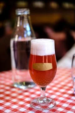 Refreshing glass of red ale beer with empty label on front of glass. Stock Photos