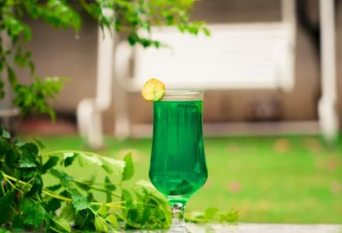Refreshing Green Drink: Lime &amp; Mint Cocktail in Garden Setting Stock Photos
