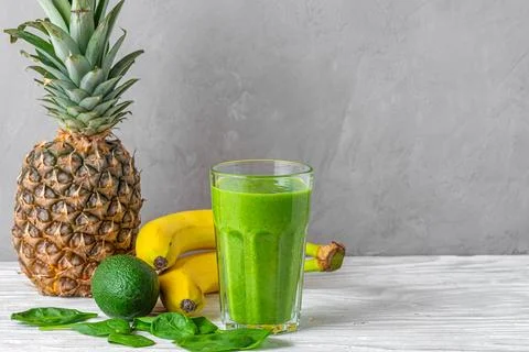 Refreshing green smoothie made of spinach, pineapple, banana and avocado in.. Stock Photos