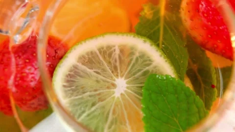 Refreshing herbal tea with lime strawberries and mint leaves Stock Footage 333828764
