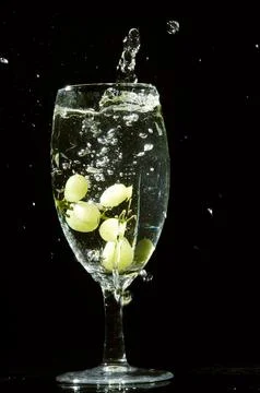 Refreshing ice cubes floating in a clear drink glas Stock Photos