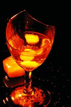 Refreshing ice cubes floating in a clear drink glas Stock Photos