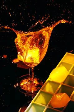 Refreshing ice cubes floating in a clear drink glas Stock Photos
