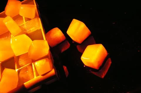 Refreshing ice cubes floating in a clear drink glas Stock Photos
