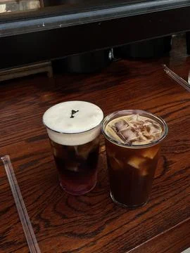 Refreshing iced beverages served in clear cups on a wooden table Stock Photos