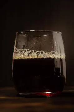 Refreshing Iced Coffee with Frothy Head in a Glass Stock Photos