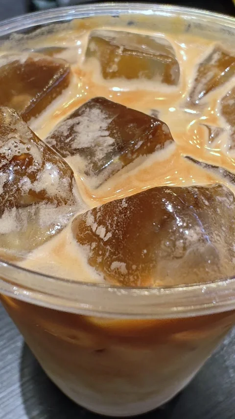 Refreshing iced coffee with ice cubes. Close-up texture of iced coffee. Stock Footage 304496809