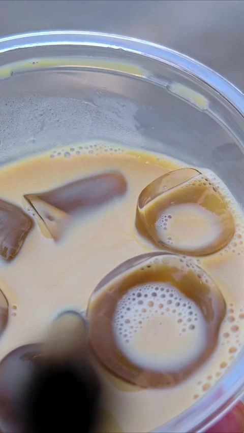 Refreshing iced coffee with ice cubes. Close-up texture of iced coffee. Stock-Footage 311126929