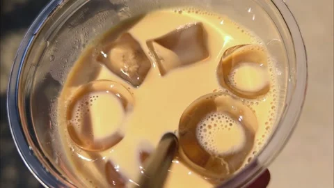 Refreshing iced coffee with ice cubes. Close-up texture of iced coffee. Stock Footage 311129598