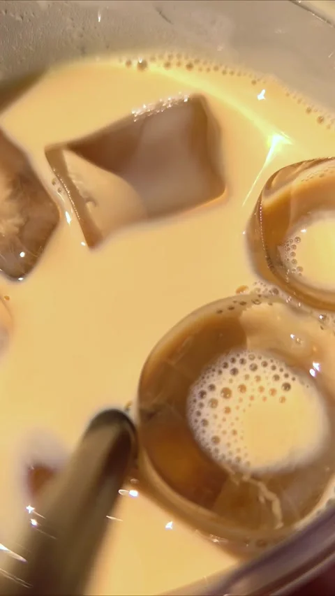 Refreshing iced coffee with ice cubes. Close-up texture of iced coffee. Stock Footage 311218896