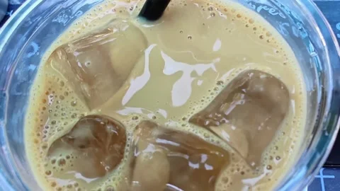 Refreshing iced coffee with ice cubes. Close-up texture of iced coffee. Stock-Footage 313532804