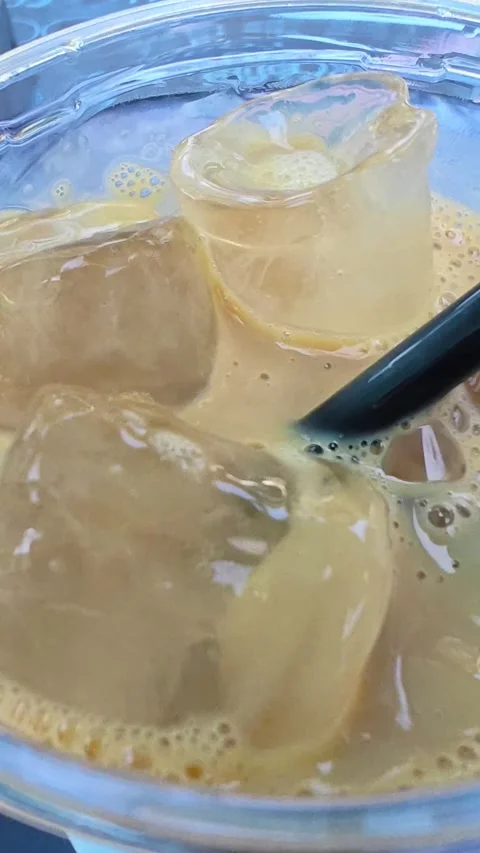 Refreshing iced coffee with ice cubes. Close-up texture of iced coffee. Stock-Footage 313800318