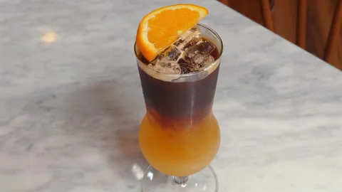 Refreshing Iced Coffee with Orange Slice on Marble Table, Modern Stock Footage 285073993