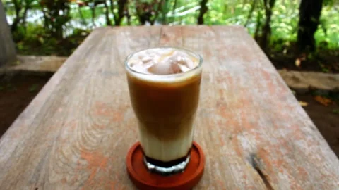 Refreshing Iced Coffee with Palm Sugar in a Glass Stock Footage 317603875