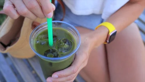 Refreshing iced green matcha tea in a plastic cup with a straw Stock Footage 315669073