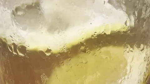 Refreshing Iced Lemon Drink with Condensation and Metal Straw Stock Footage 331251174