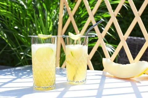 Refreshing iced melon cocktail or smoothie garnished with a sprig of mint. The Stock Photos