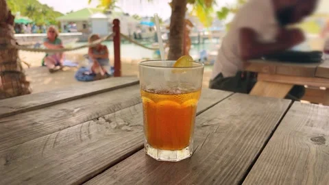 The refreshing, iced orange cocktail with a straw while relaxing. Stock-Footage 327683664