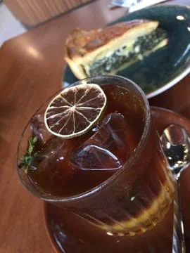 Refreshing iced tea and quiche on cafe table Stock Photos