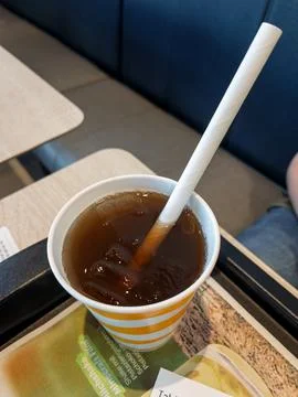 Refreshing Iced Tea Beverage in Orange Striped Cup Stock Photos