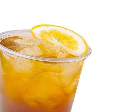 Refreshing iced tea with lemon slice in a clear cup on a white background Stock Photos