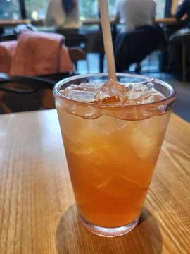 Refreshing iced tea served in a chilled glass, featuring a deep amber hue a.. Stock Photos