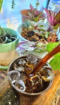 Refreshing iced tea served in a chilled glass, featuring a deep amber hue a.. Stock Photos